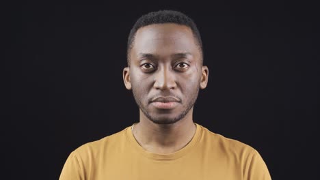 Close-up-portrait-of-unhappy-and-sad-African-young-man.